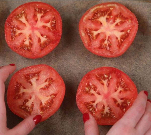 Place halved tomatoes on a baking pan for a yummy delight that only takes 15 minutes